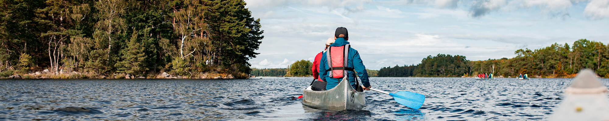 Man in a canoe on the Rideau Lake enjoying the weather